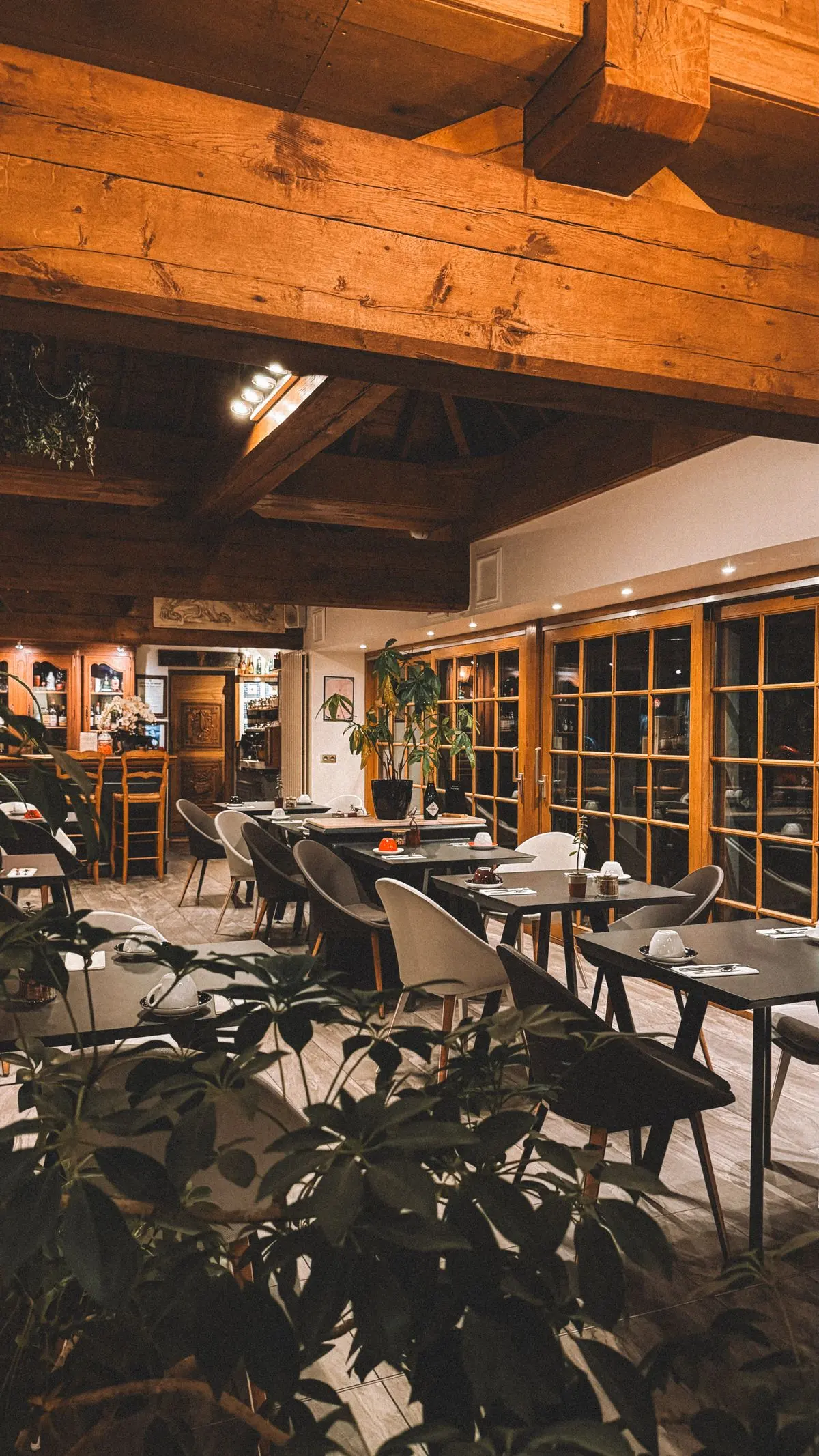 Warm, timber-beamed restaurant interior with ambient lighting