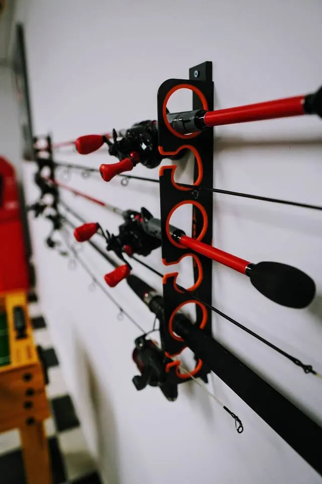 Six fishing rods of varying sizes mounted on the wall by the door
