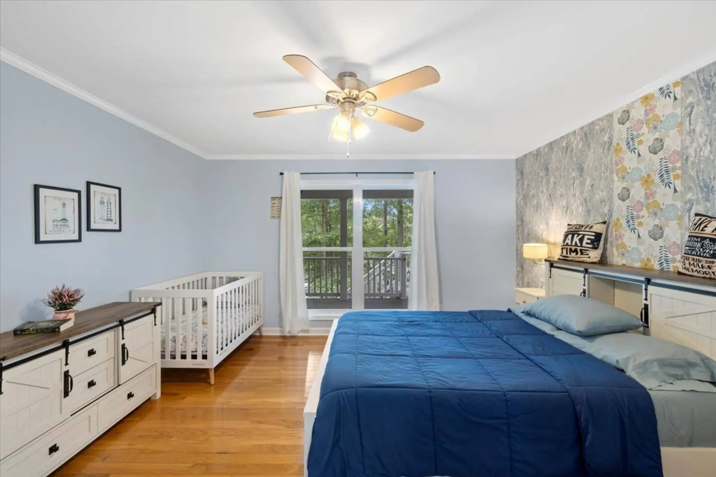 Bright bedroom with a made-up bed and crisp white-and-blue linens